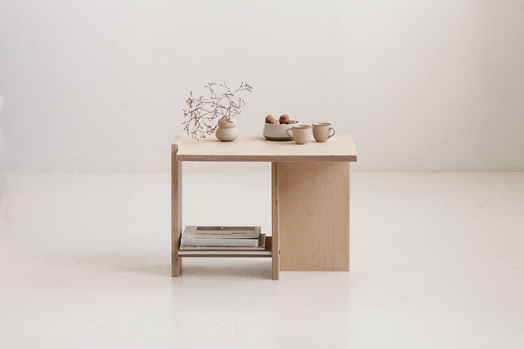Wooden desk with decorative items on a white background