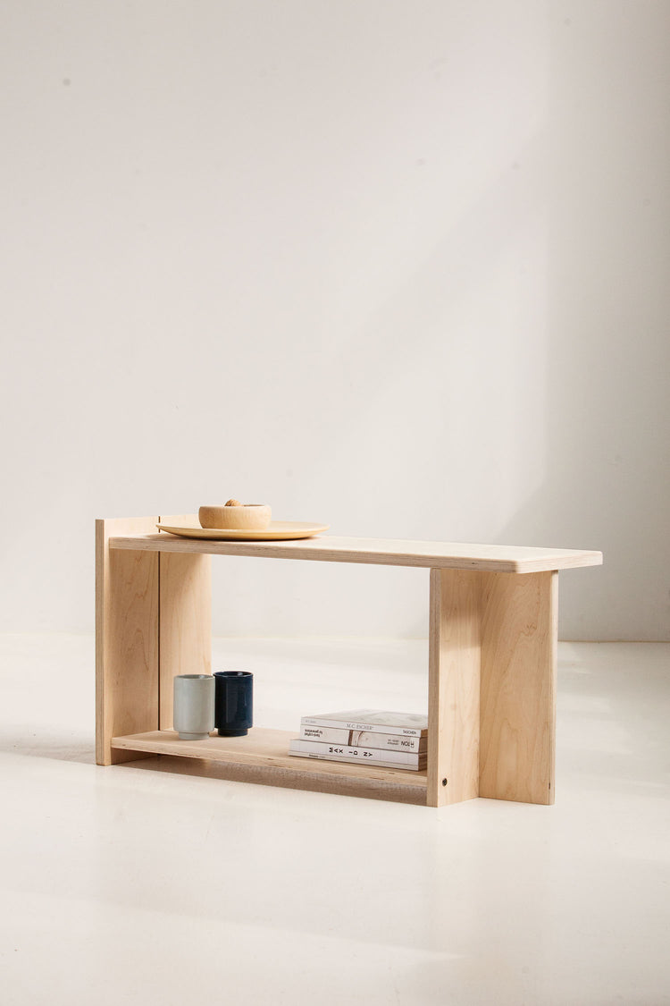 Wooden bench with a minimalistic design against a plain background