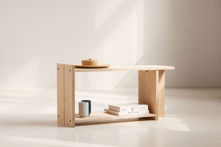 Wooden bench with books and a bowl on a white background