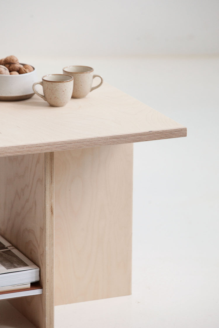 Light wooden desk with two ceramic cups on a white background