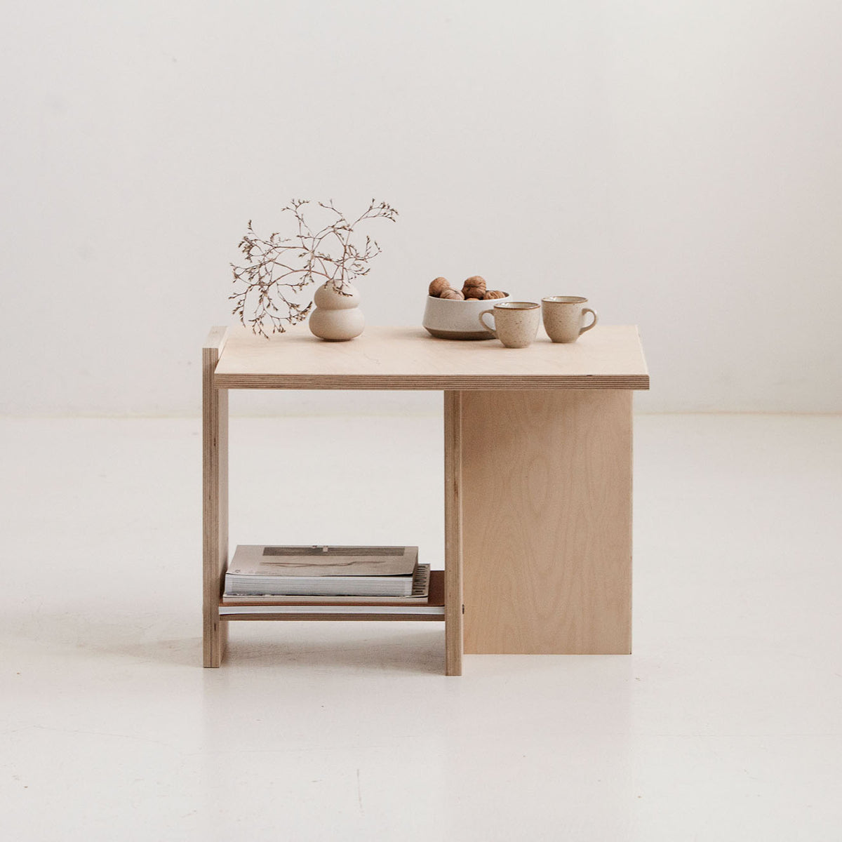 Wooden desk with decorative items on a white background