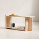 Minimalist wooden bench with a few items on a plain background