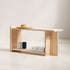 Minimalist wooden bench with a few items on a plain background