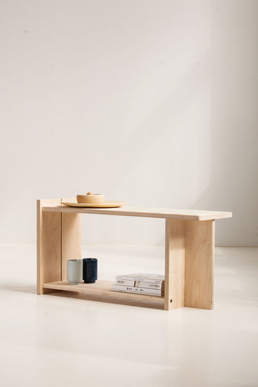 Wooden bench with a minimalistic design against a plain background