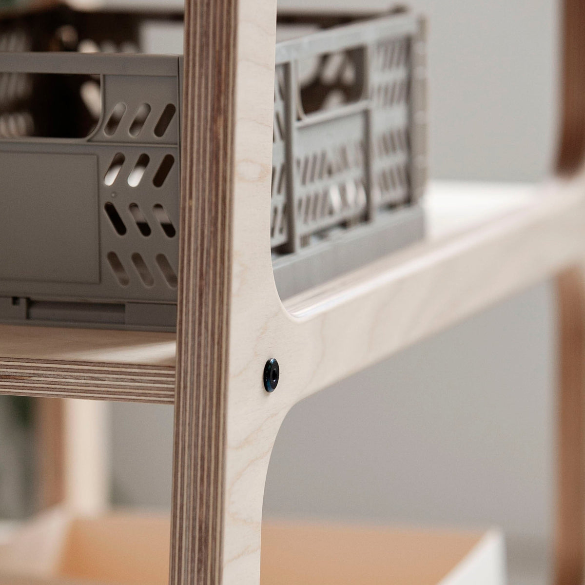 Detail-of-Mid-century-modern-l-shape-desk-with-drawers-and-shelves-in-natural-wood-stain